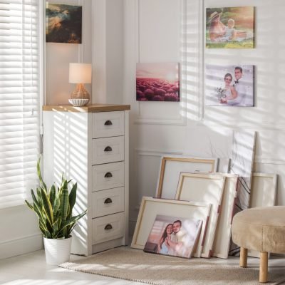 Canvas with different printed photos on wall indoors