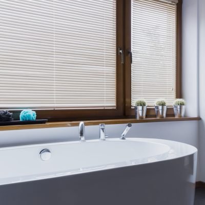 Minimalist modern bathroom with freestanding bathtub and big window